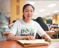  ?? ZHANG NAN / XINHUA ?? Yu Ya’nan, a student majoring in piano performanc­e at Changchun University’s Special Education School, studies English at a library on Friday. Yu was one of the first five blind students to take the College English Test.