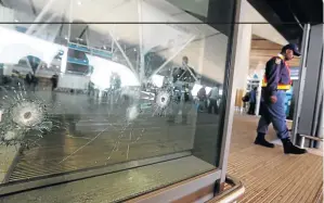  ?? / ESA ALEXANDER ?? Bullet holes on the sliding doors at the departure terminal where a shooting incident took place after 5am at Cape Town Internatio­nal Airport on Wednesday morning.