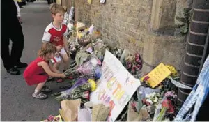  ??  ?? Children lay flowers, close to Finsbury Park Mosque in north London yesterday