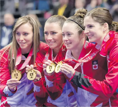  ?? JUSTIN TANG / THE CANADIAN PRESS ?? Skip Rachel Homan, third Emma Miskew, second Joanne Courtney and lead Lisa Weagle hold up their medals after winning the women’s final 6-5 over Cheslea Carey’s rink at the Roar of the Rings Olympic trials on Sunday in Ottawa.