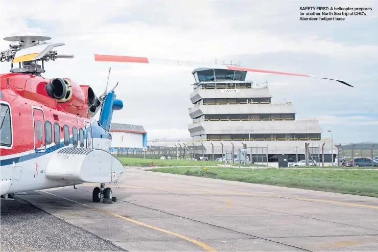  ??  ?? SAFETY FIRST: A helicopter prepares for another North Sea trip at CHC’s Aberdeen heliport base