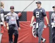  ??  ?? Atlanta quarterbac­k Matt Ryan (2) talks with teammate Matt Simms (left) during a workout at the team’s practice facility in Flowery Branch.