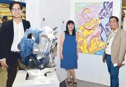  ??  ?? SM SVP for marketing Millie Dizon (center) with the Metropolit­an Museum of Manila’s Daniel Devela (left) and SM City Iloilo mall manager Gilbert Domingo beside the works of Martin Genodepa, Mia Reyes and Harry Mark Gonzales.