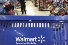  ??  ?? In this June 5, 2017, file photo, customers shop for food at Walmart in Salem, N.H. Walmart says it will no longer sell firearms and ammunition to people younger than 21. The retailer’s new policy comes after Dick’s Sporting Goods announced earlier...