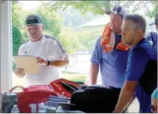  ?? Lynn Atkins/The Weekly Vista ?? Paul Pautsch (left) reads the team assignment­s for the Cancer Challenge adult tennis tournament. Pautsch retired as the POA tennis pro but continued to run the Cancer Challenge Tournament. Now after 25 years, he’s ready to step down and let the new POA pro Jake Shoemake take over the tournament.