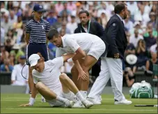  ?? ALASTAIR GRANT - THE ASSOCIATED PRESS ?? Serbia’s Novak Djokovic helps Italy’s Jannik Sinner to his feet after he slipped while chasing down a ball in a men’s singles quarterfin­al match at Wimbledon on Tuesday.