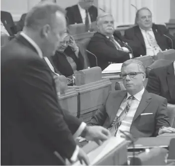  ?? MARK TAYLOR / THE CANADIAN PRESS ?? Saskatchew­an Premier Brad Wall listens to Finance Minister Kevin Doherty’s budget speech last week. The province predicts a return to surplus by 2019 via a painful program of spending cuts and tax hikes.