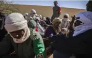  ??  ?? Former rebels wait at a police station to help the Malian military with joint patrols as part of a peace agreement.