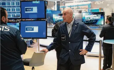  ?? Spencer Platt / Getty Images ?? Traders work the floor of the New York Stock Exchange on Thursday as stocks continued to nose-dive.