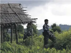  ?? EPA ?? Myanmar police officers guard Maungdaw township in Rakhine State, western Myanmar, in September last year