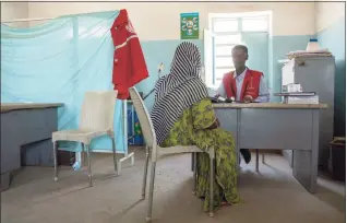  ?? Nariman El-Mofty / Associated Press ?? A Tigrayan woman who says she was gang raped by Amhara fighters speaks to surgeon and doctor-turned-refugee, Dr. Tewodros Tefera, at the Sudanese Red Crescent clinic in Hamdayet near the Sudan-Ethiopia border, eastern Sudan, on March 23. “Let the Tigray government come and help you,” she recalled them saying, even while they were raping her.