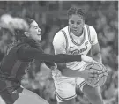  ?? AARON E. MARTINEZ/AMERICAN-STATESMAN ?? Texas freshman Madison Booker protects the ball from BYU guard Kaylee Smiler during their game March 2 at Moody Center. Booker, the Big 12 co-player of the year, leads the Longhorns into this week’s NCAA Tournament.