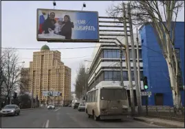  ?? THE ASSOCIATED PRESS ?? A billboard promotes the upcoming presidenti­al election with words in Russian: “Time to vote” Wednesday on a street in the Russiancon­trolled Donetsk region of eastern Ukraine. Presidenti­al elections are scheduled in Russia for Sunday.