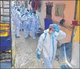  ??  ?? Health workers during a screening drive in Malad on Thursday.