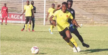  ?? ?? Chicken Inn FC’s Brett Amidu shields the ball away from the Harare City FC’s Donald Mudadi during the Castle Lager Premier soccer league match played at Luveve Stadium yesterday. (Picture by Nkosizile Ndlovu)