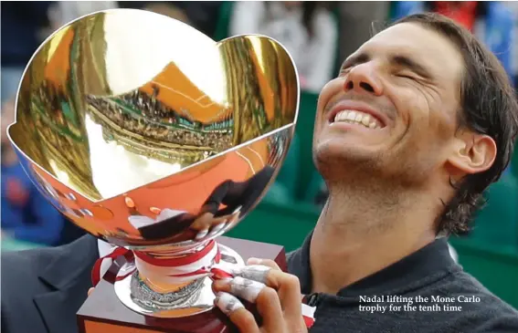  ??  ?? Nadal lifting the Mone Carlo trophy for the tenth time