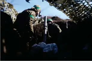  ?? ?? Ukrainian troops prepare to fire a mortar from a position near Bakhmut (AFP/Getty)