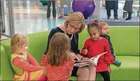  ?? SARAH CAVENDER/STAFF PHOTO ?? Ohio first lady Fran DeWine reads to children during a Dec. 18 visit to Dayton Children’s Hospital.