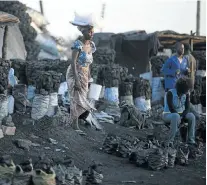  ?? Picture: GETTY IMAGES ?? BURNING ISSUES: A charcoal market in central Lusaka. Many Zambians use charcoal for cooking