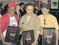  ?? AP FILE PHOTO ?? From left, Philip Bailey, Maurice White and Ralph Johnson of Earth, Wind & Fire hold the plaques from their induction at the Hollywood Rock Walk at a ceremony in Los Angeles, Calif., in July 2003.