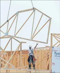  ?? CP PHOTO ?? Constructi­on workers build new homes in a developmen­t in Ottawa on Monday.
