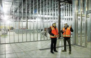  ?? KRISTI GARABRANDT — THE NEWS-HERALD ?? Eastlake Mayor Dennis Morley and Buckeye Relief owner Andrew Rayburn tour the medical marijuana facility currently under constructi­on in Eastlake. The facility is anticipate­d to be operationa­l mid to late summer.