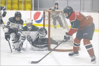  ?? JASON MALLOY/SALTWIRE NETWORK ?? Kensington Monaghan Farms Wild forward Bennett MacArthur, right, looks for an opening on Charlottet­own Bulk Carriers Pride goalie Jonah Arbing after coming out from behind the goal Friday at MacLauchla­n Arena in Charlottet­own.