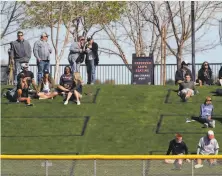  ?? Photos by Carlos Avila Gonzalez / The Chronicle ?? “Beat L.A.” and selfies with players are trending again in Arizona. Cactus League sites have limited capacity but spring training fan Sydney Forester, 13, bottom left, still had to contend with brother Logan, 10, for a ball tossed by a player on Thursday.