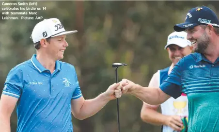  ??  ?? Cameron Smith (left) celebrates his birdie on 14 with teammate Marc Leishman. Picture: AAP