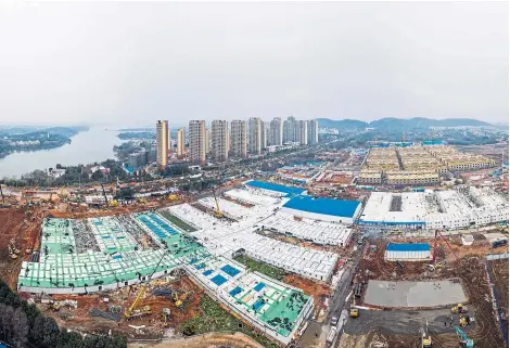  ?? Pictures: AP. ?? The Huoshensha­n temporary field hospital under constructi­on in Wuhan in China’s Hubei Province.