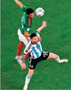  ?? Reuters ?? ■ Mexico’s defender Hector Moreno and Argentina’s Lionel Messi fight for the ball at the Lusail Stadium last night.