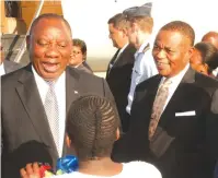  ??  ?? South African President and Sadc Chairperso­n Cyril Ramaphosa receives a garland, while Vice-President Constantin­o Chiwenga looks on at Robert Mugabe Internatio­nal Airport in Harare yesterday.