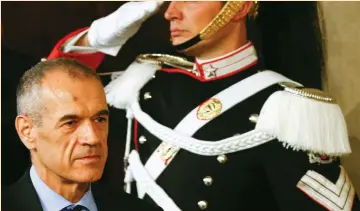  ?? (Reuters) ?? PRIME MINISTER-DESIGNATE Carlo Cottarelli arrives to talk to the media after a meeting with Italy’s President Sergio Mattarella in Rome on Monday.