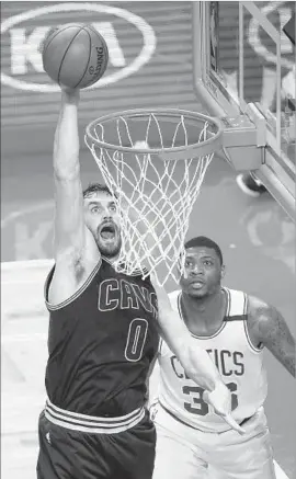  ?? Adam Glanzman Getty Images ?? KEVIN LOVE of the Cleveland Cavaliers goes for a dunk in front of Marcus Smart of the Boston Celtics for two of his playoff career-high 32 points.