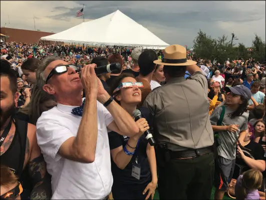  ?? Photo courtesy of The Planetary Society ?? Bill Nye “the Science Guy” and astronomer Amy Mainzer during totality at a public viewing event put on by the National Park Service in Beatrice, Neb., for the 2017 solar eclipse.