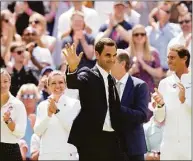  ?? Kirsty Wiggleswor­th / Associated Press ?? Roger Federer is applauded as he arrives to take part in a celebratio­n of 100 years of Centre Court at Wimbledon on Sunday in London.