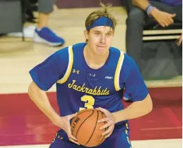  ?? CHARLIE NEIBERGALL/AP ?? South Dakota State guard Baylor Scheierman looks to pass during the second half of a game against Iowa State on Dec. 2, 2020, in Ames, Iowa.Scheierman’s decision to return to his home state and play for Creighton after three stellar seasons at South Dakota State gave the Bluejays one of the nation’s more versatile players.