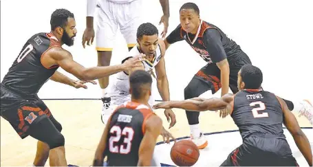  ?? STAFF PHOTO BY ROBIN RUDD ?? UTC’s Rodney Chatman is surrounded by the Mercer defense during Saturday’s 64-54 SoCon loss at McKenzie Arena.