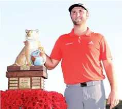  ??  ?? Rahm poses with the trophy after winning the Hero World Challenge at Albany, Bahamas. — AFP photo