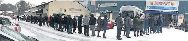  ??  ?? ●●Rochdale fans queue in the snow for tickets to the FA Cup fifth round tie against Tottenham Hotspur at the Crown Oil Arena