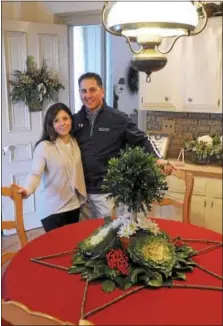  ?? GENE WALSH — DIGITAL FIRST MEDIA ?? Homeowners Tim and Jaime Forsyth pose in their kitchen during the Norristown Garden Club’s 68th Annual Holiday House Tour Thursday, Dec. 7, 2017.