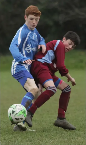  ??  ?? Andrew Byrne of Wexford Celtic and Evan Ryan of Ferns United battle for the ball during their Youths Division 1 match in Sinnottsto­wn Lane on Saturday.