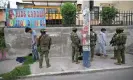  ?? AFP/Getty Images ?? Members of the army’s elite forces inspect men and check their identity during a patrol in the streets of Carapungo, a popular neighbourh­ood in northern Quito. Photograph: