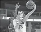  ?? JESSICA HILL/AP ?? Connecticu­t’s Katie Lou Samuelson shoots as UCLA’s Kennedy Burke (left) defends during the second half of a regional semifinal on Saturday in Bridgeport, Conn.