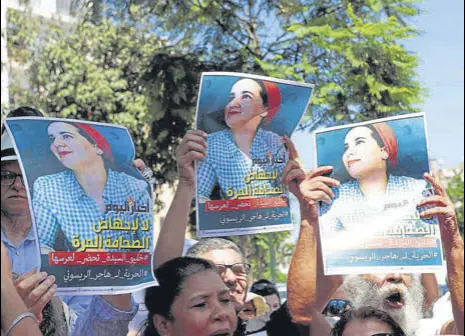  ?? REUTERS ?? Moroccan activists hold posters of Hajar Raissouni during a protest outside the Rabat tribunal in the Moroccan capital.