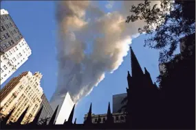  ?? Mario Tama/Getty Images/TNS ?? Smoke spews from a tower of the World Trade Center on Sept. 11, 2001, after two hijacked airplanes hit the twin towers in a terrorist attack on New York City.