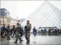  ?? THE ASSOCIATED PRESS ?? French soldiers patrol in the courtyard of the Louvre museum in Paris on Feb. 4. The soldiers of France’s Sentinelle operation, along with other security forces patrolling French streets, are increasing­ly the main targets of attacks by Islamic radicals.