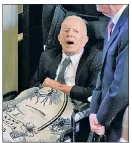  ?? ?? DETERMINED: Jimmy Carter attends in a wheelchair, covered by a blanket with Rosalynn’s picture.