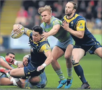  ??  ?? Worcester’s Bryce Heem is tackled by Newcastle’s Nili Latu (grounded) and Charlie Harris