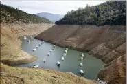  ?? RICH PEDRONCELL­I — THE ASSOCIATED PRESS FILE ?? Houseboats float in the drought-lowered waters of Oroville Lake near Oroville in 2014.